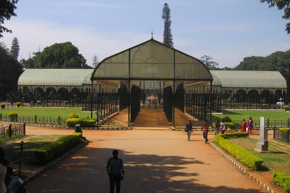 a large building with people walking in a park