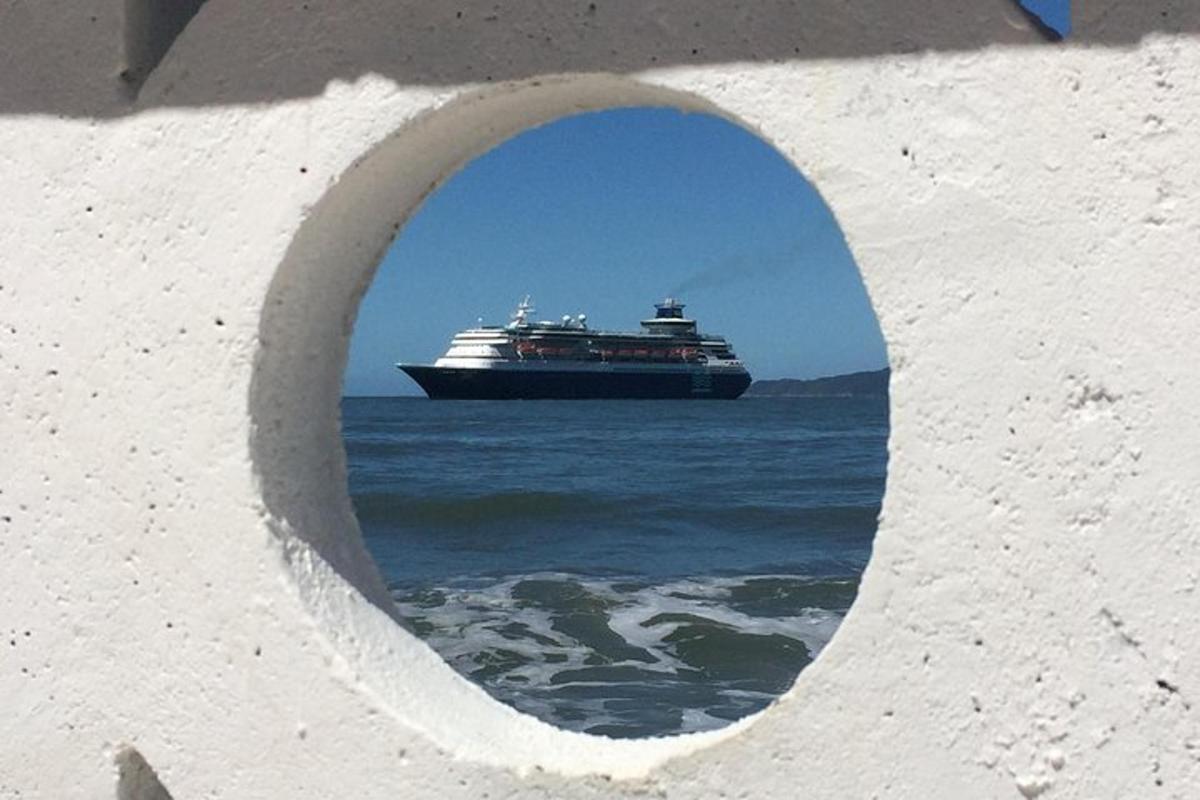 a cruise ship in the ocean through a hole in a wall