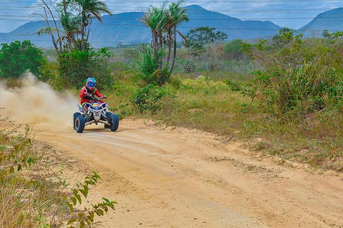 a person riding a quad bike on a dirt road