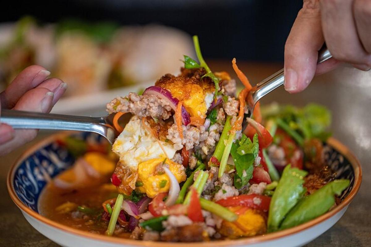 a person eating a bowl of food with a fork
