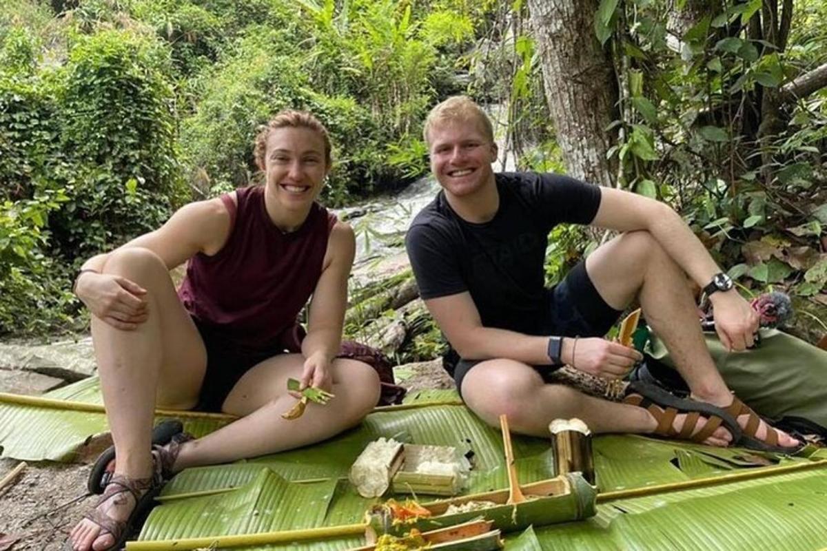 a man and woman sitting on a green blanket