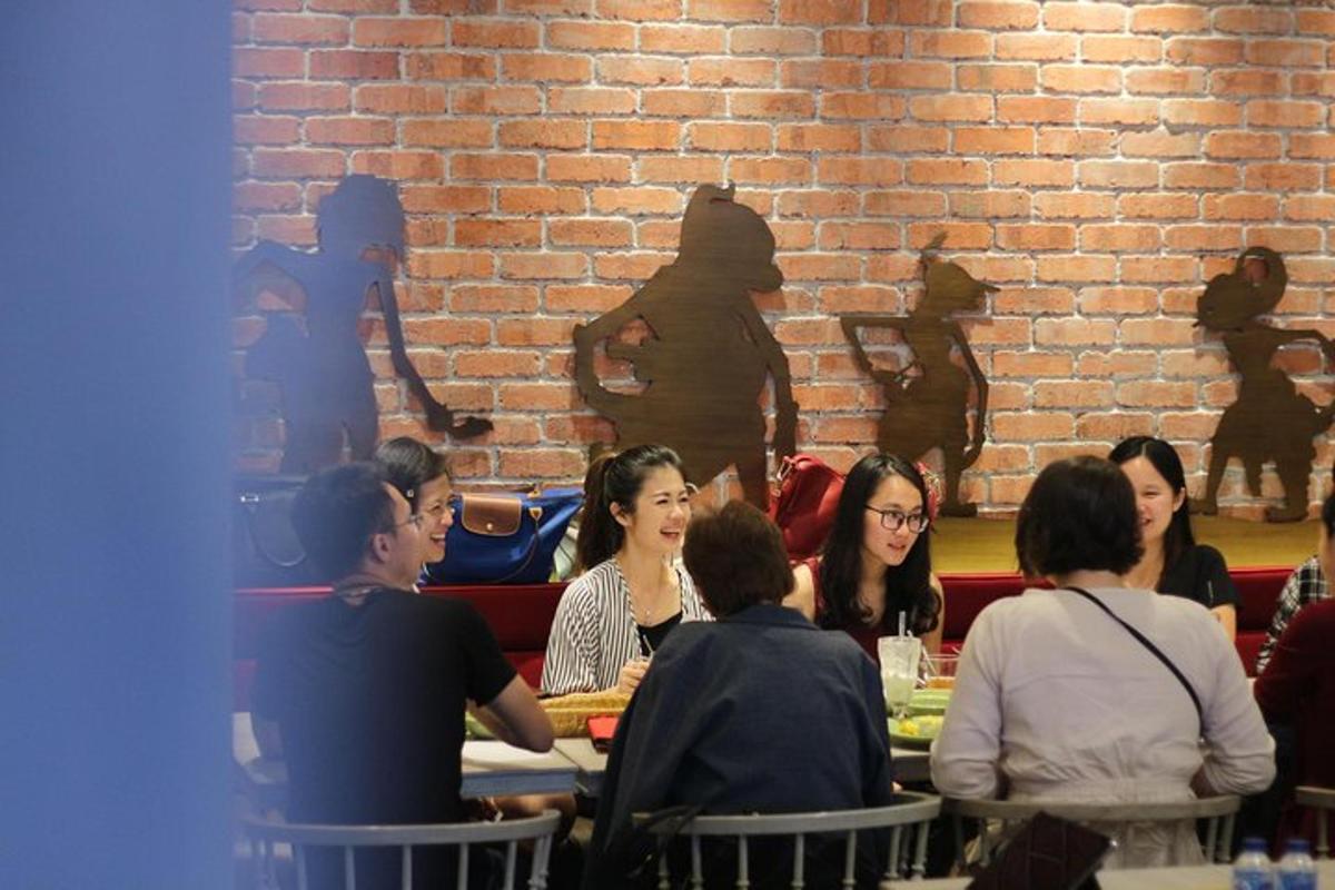a group of people sitting at a table in a restaurant