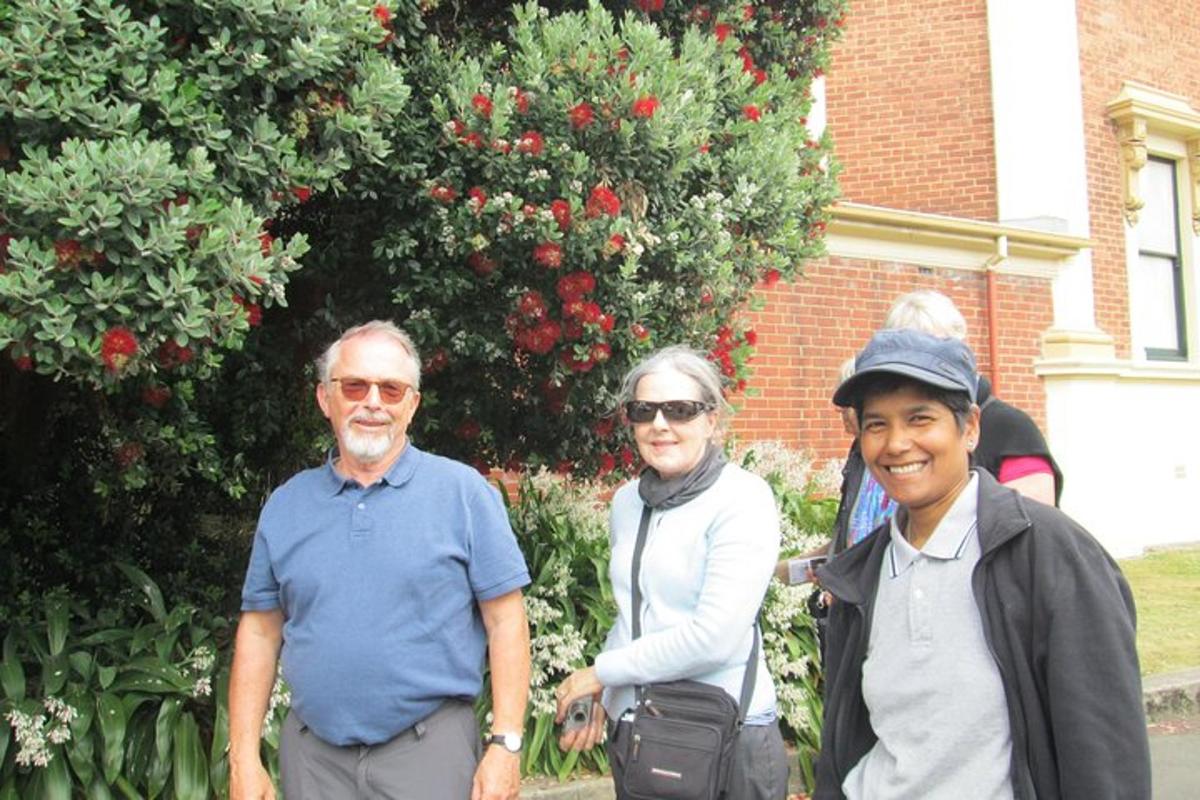 a group of people standing in front of a garden