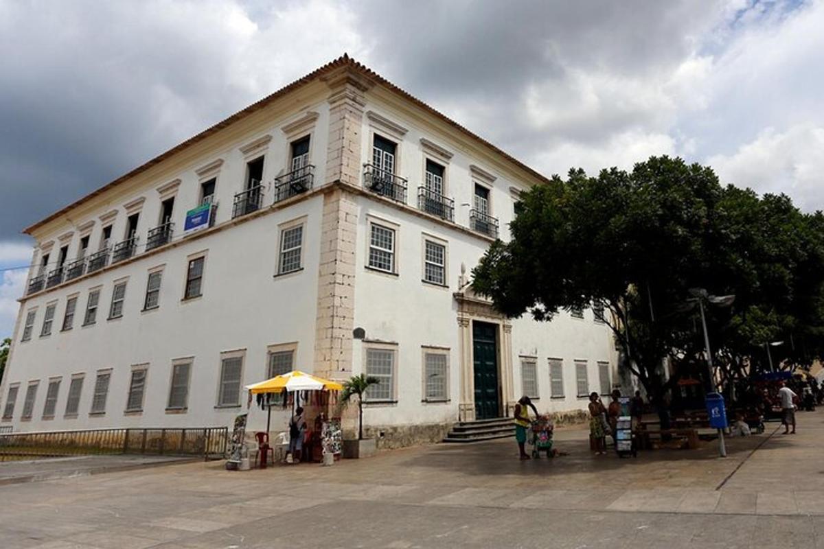 a large white building with people standing outside of it