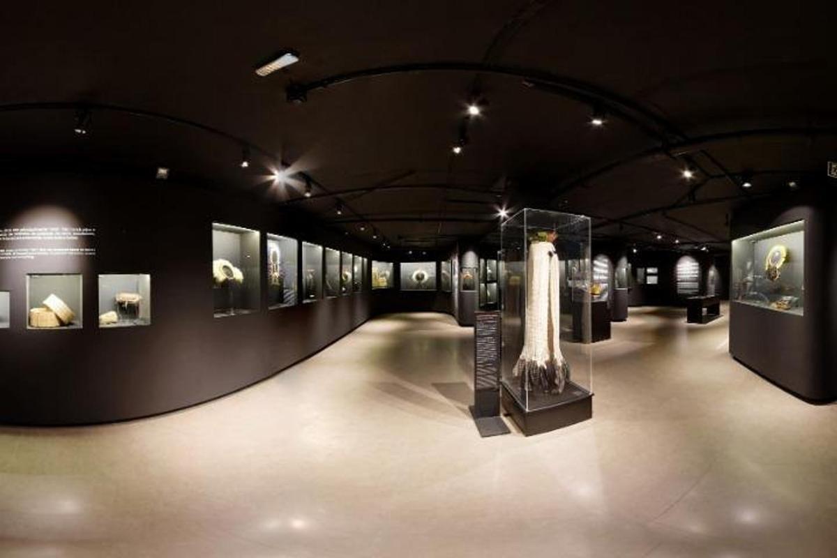 a museum exhibit with a vase and other exhibits