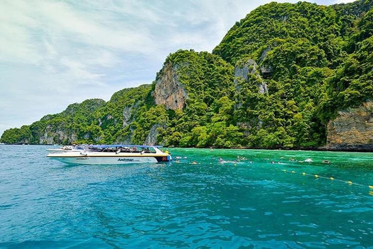 a boat in the water in front of a mountain
