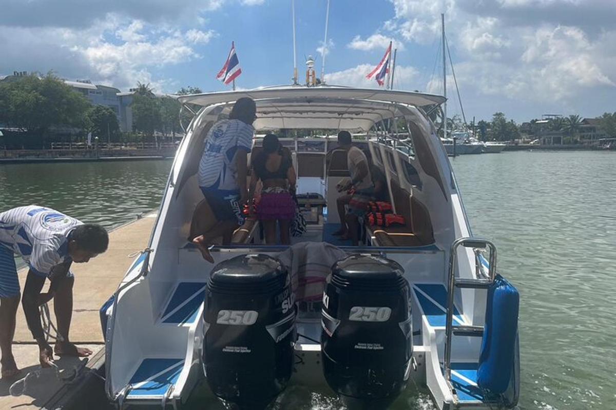 a group of people sitting in the back of a boat