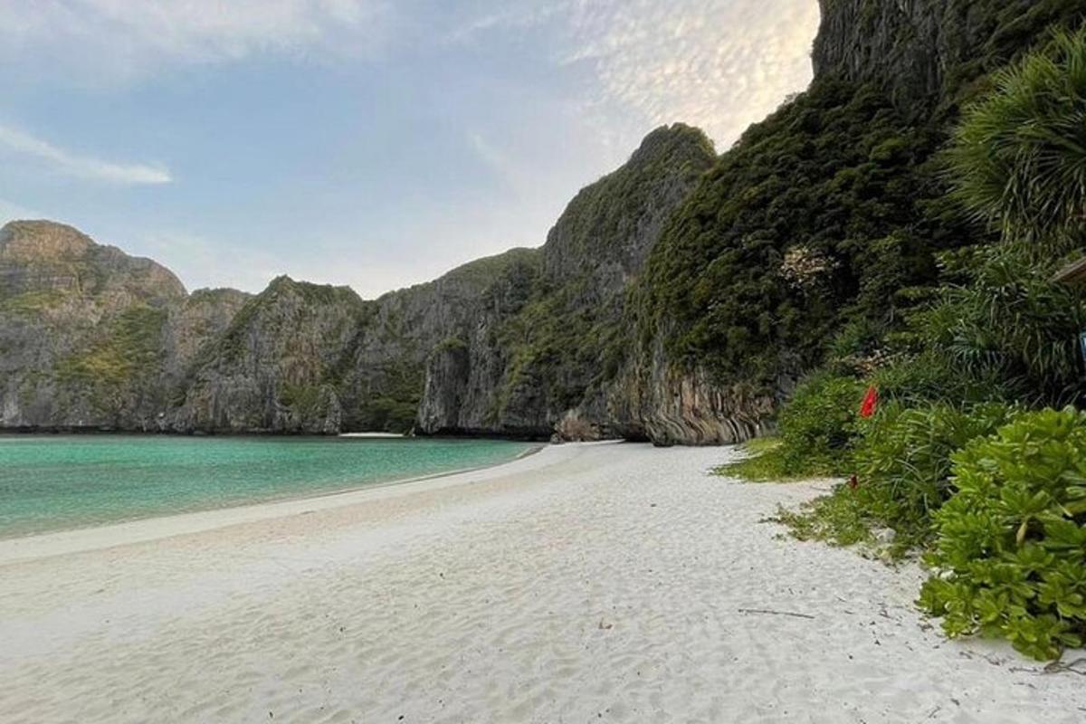 a beach with a white sand and blue water