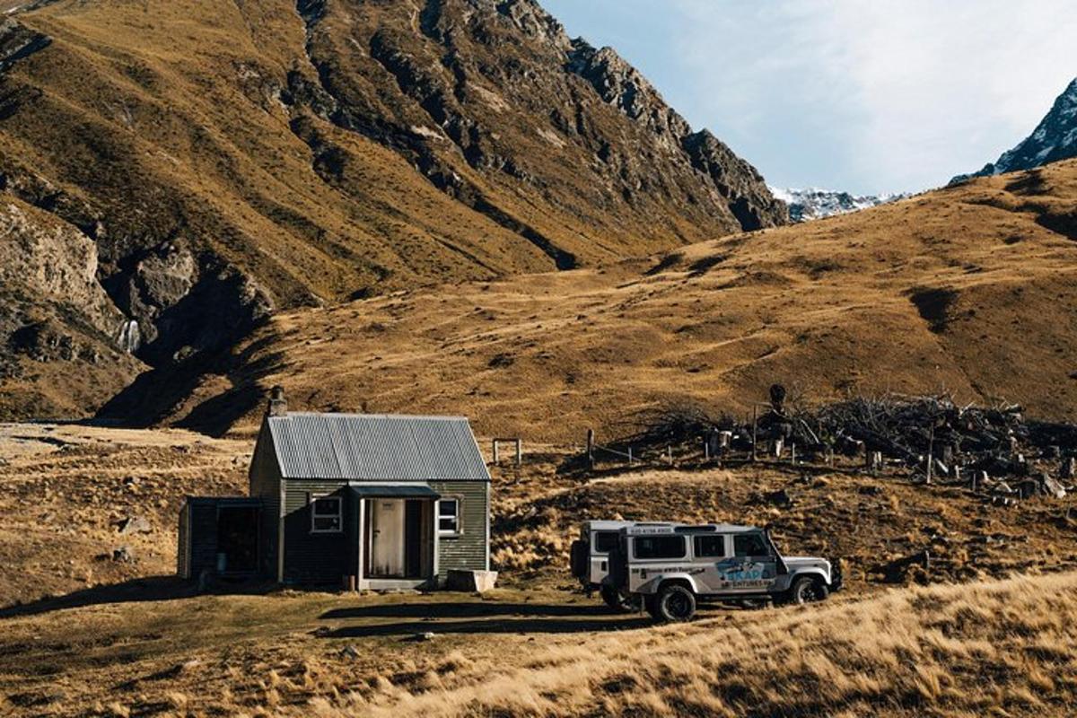 a truck parked in front of a small house on a hill