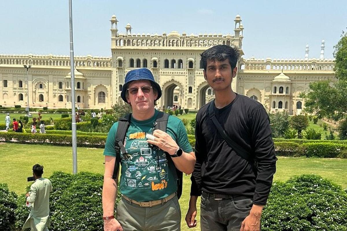 two men standing in front of a large building