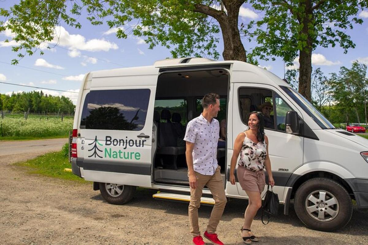 a man and a woman standing in front of a van