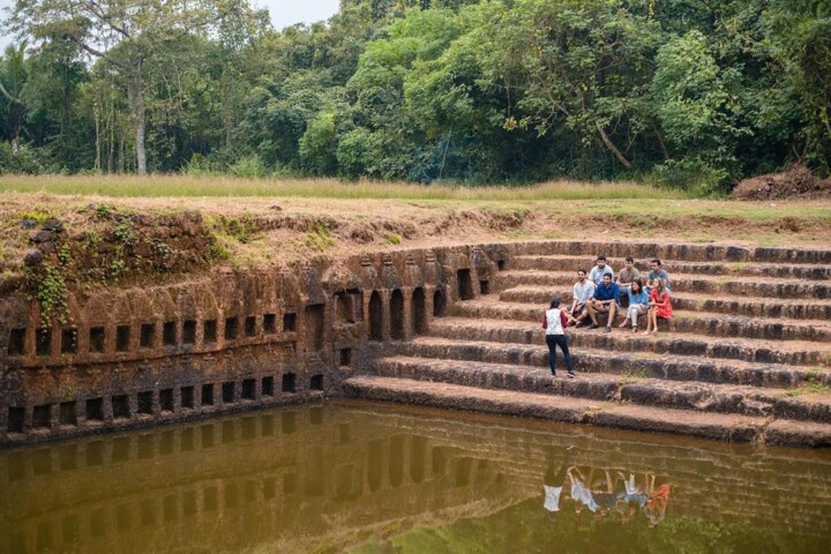 a group of people sitting on the steps by the water