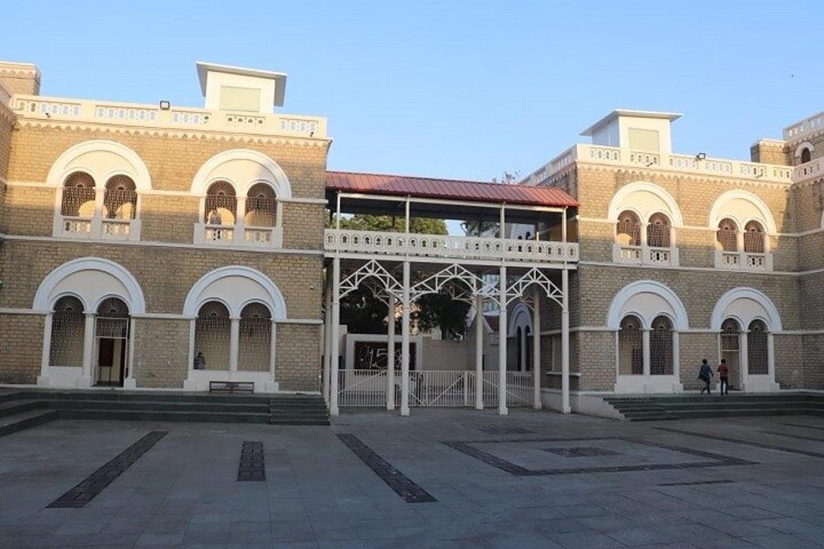 a large brick building with a balcony on top