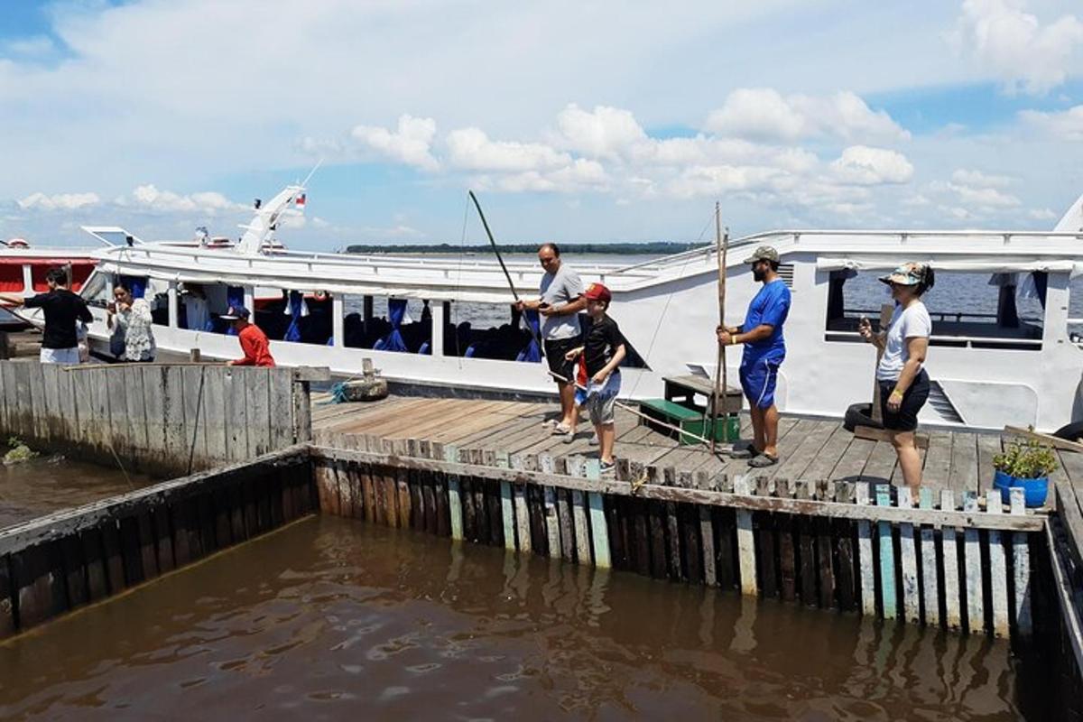 a group of people standing on a dock next to a boat