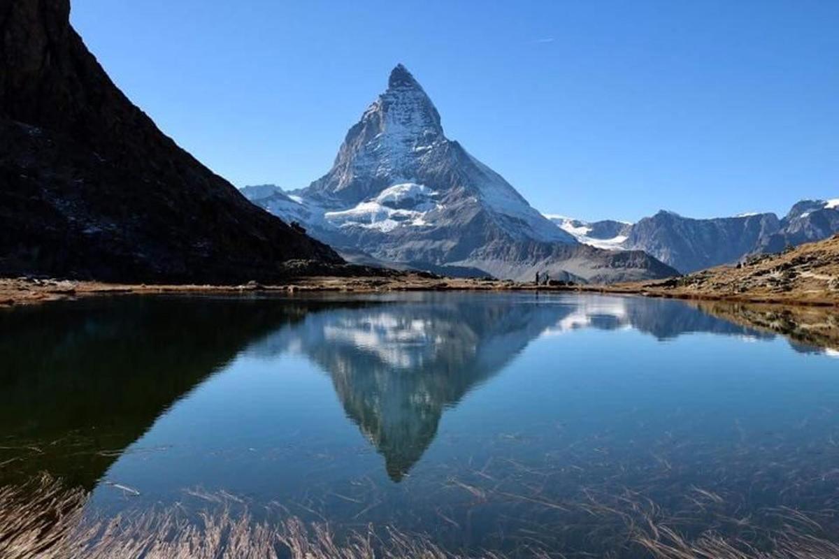 a mountain with its reflection in a body of water