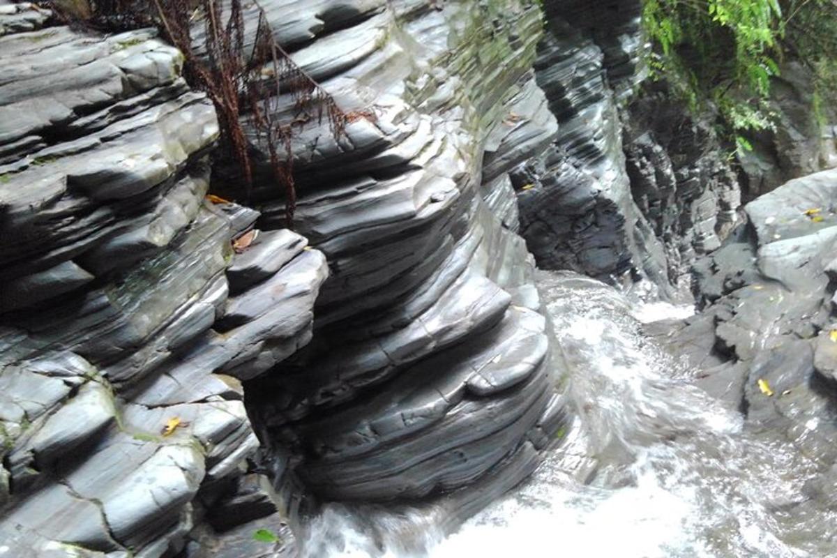 a rock wall with water running down it