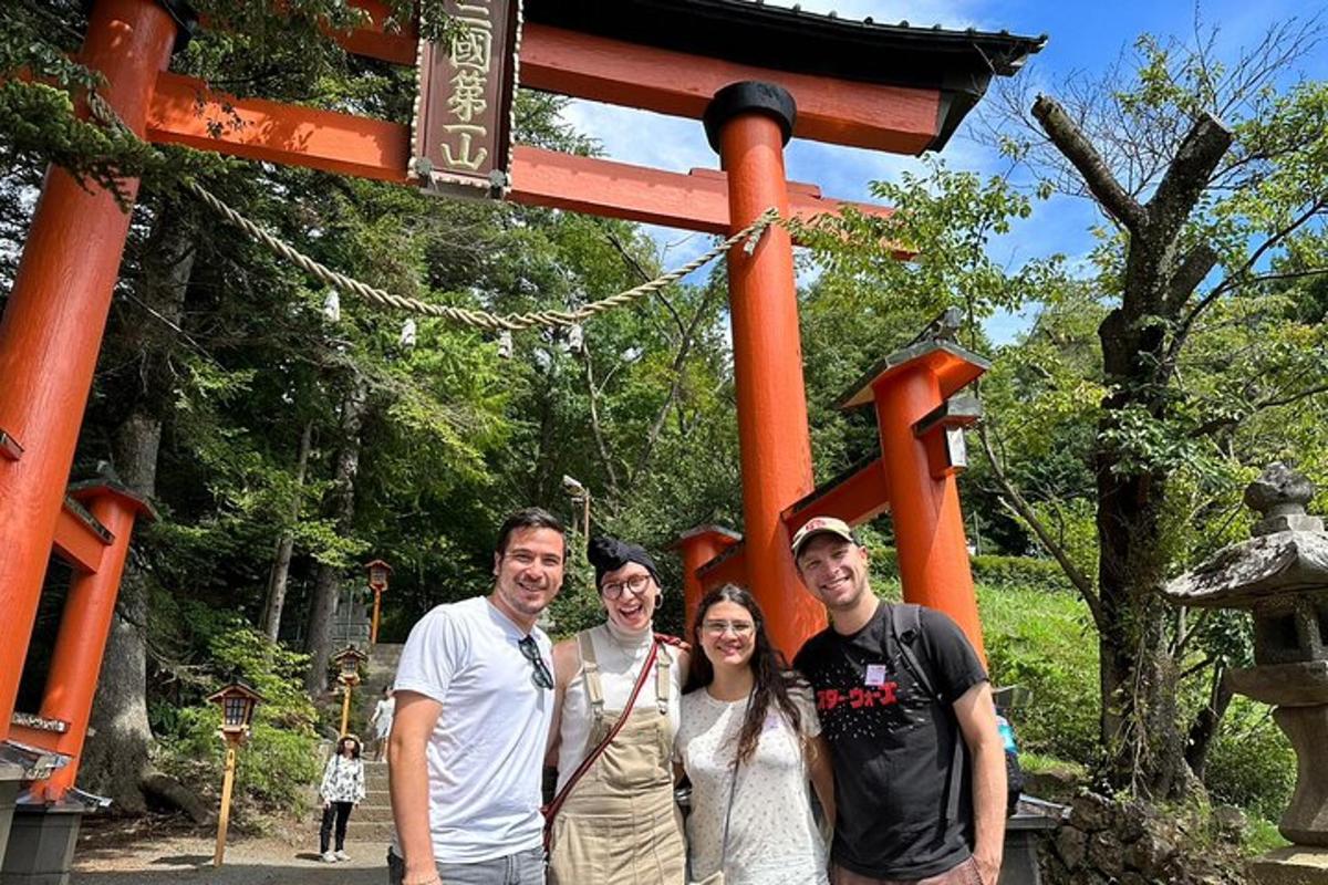 a group of people posing for a picture in front of a gate