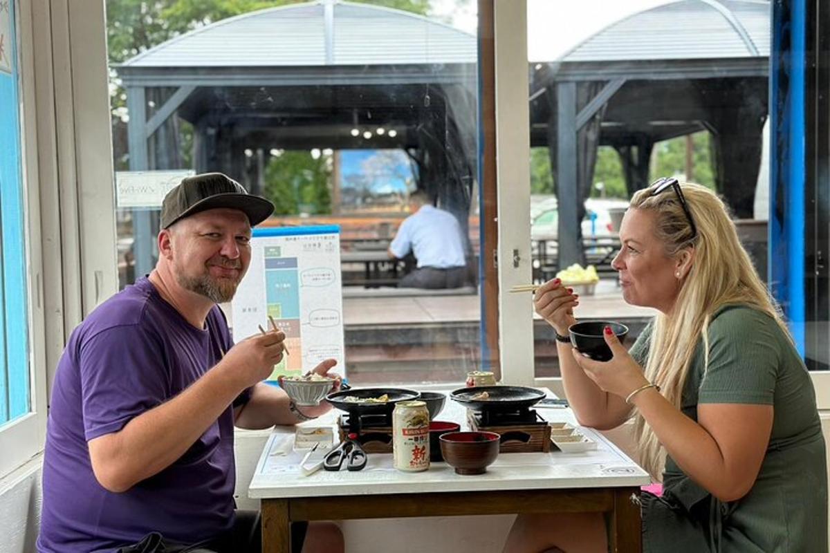 a man and a woman sitting at a table eating food