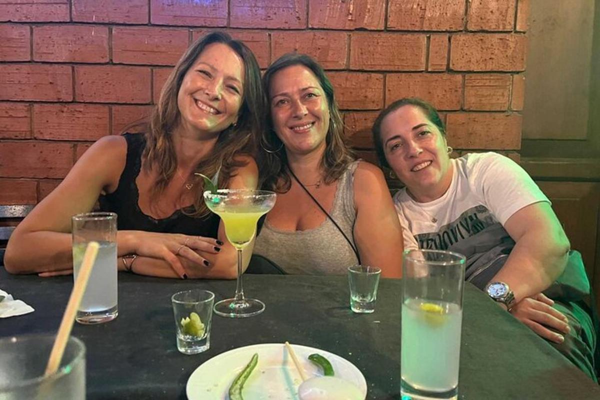 three women posing for a picture at a table