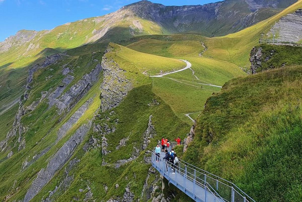 a group of people standing on a bridge on a mountain
