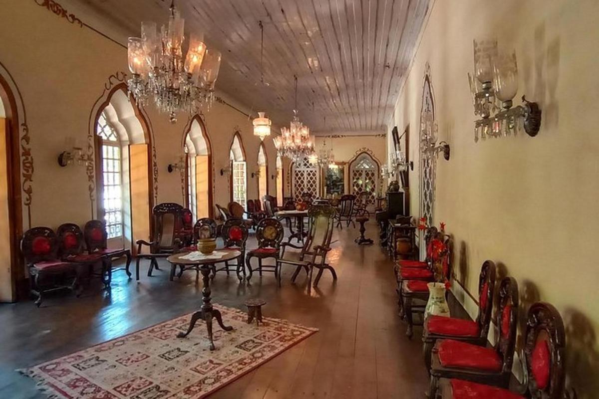 Una gran sala con sillas y mesas y una lámpara de araña.