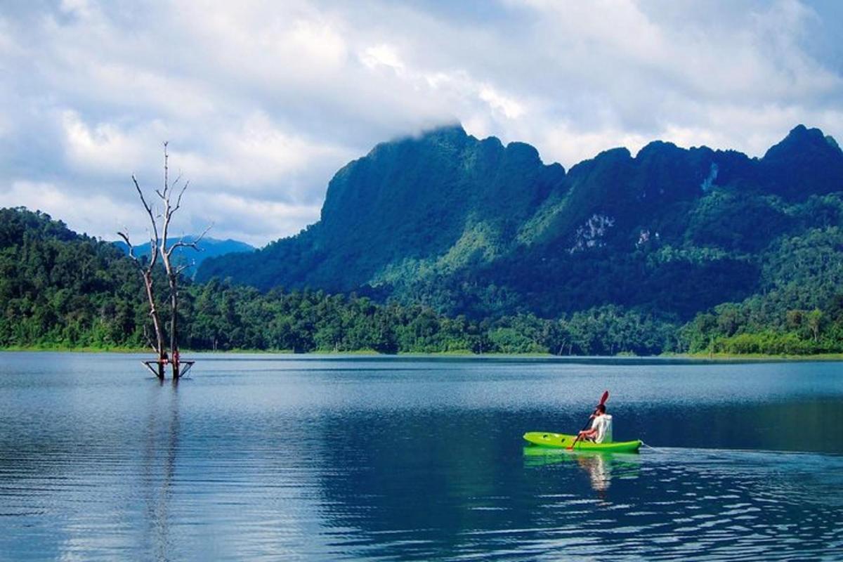 a person in a green kayak on a lake
