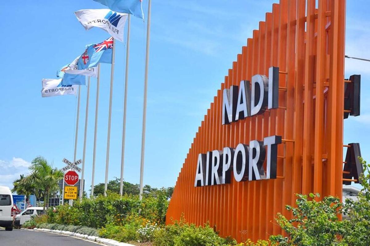 a sign for a nada airport with flags on it