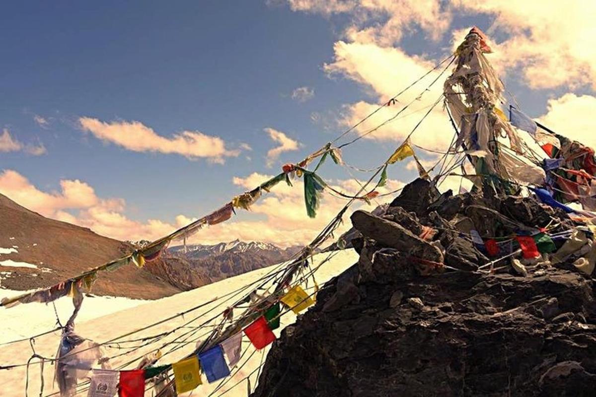 a mountain with prayer flags on top of it