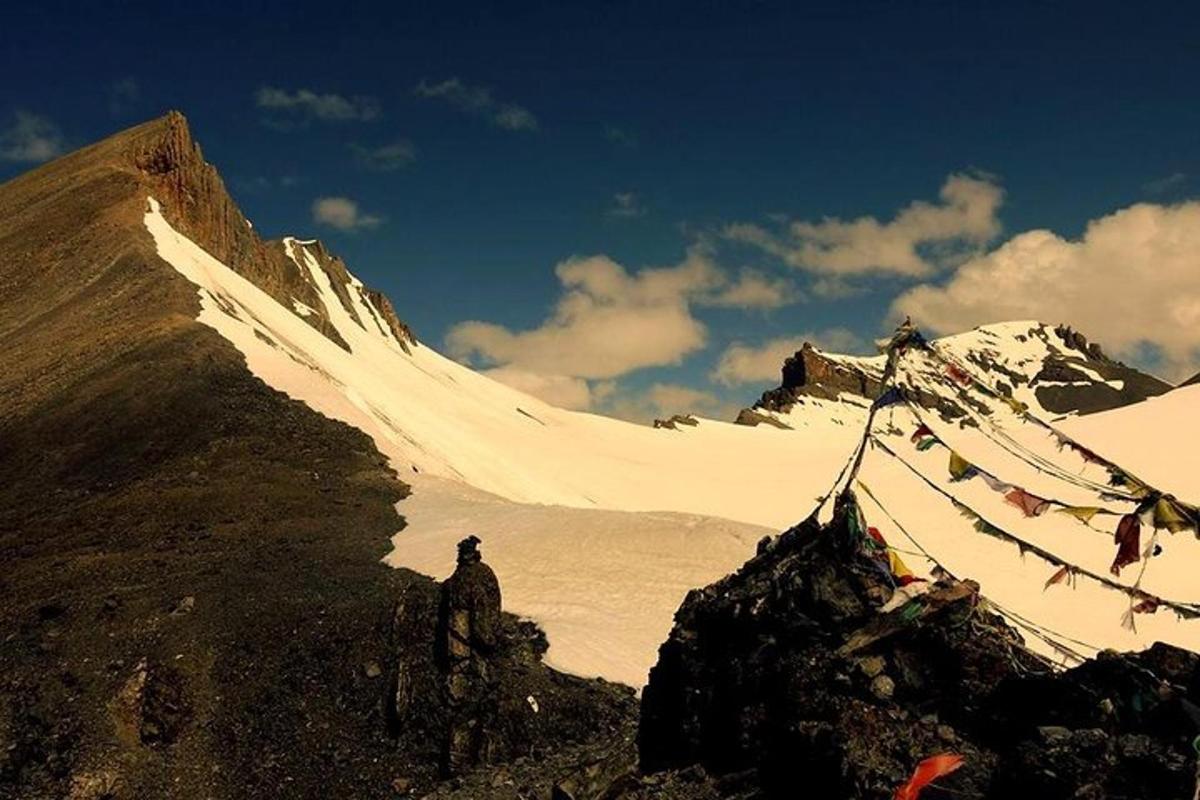 a person standing on top of a snow covered mountain