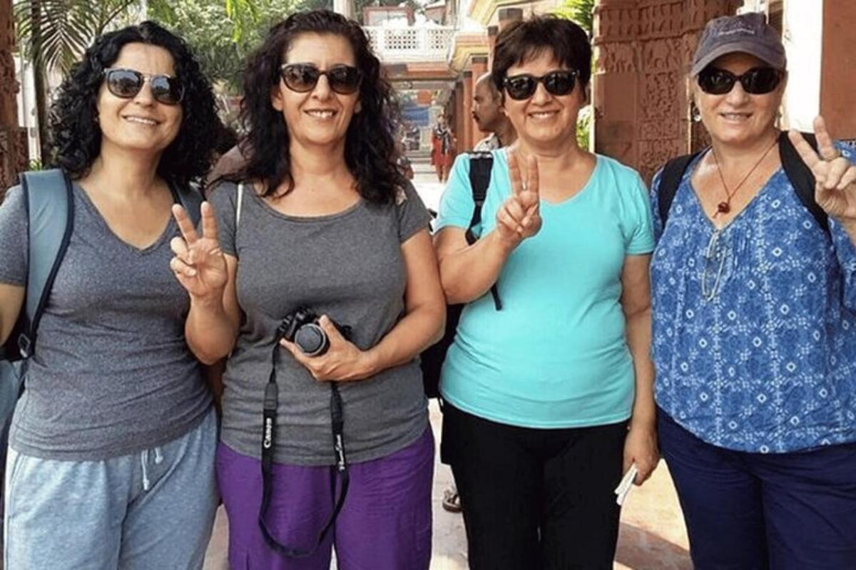 a group of women standing together with their hands up