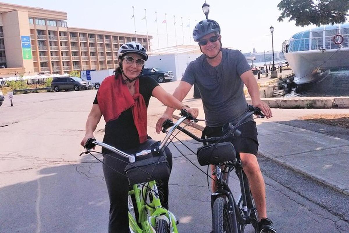 a man and a woman riding bikes on a street