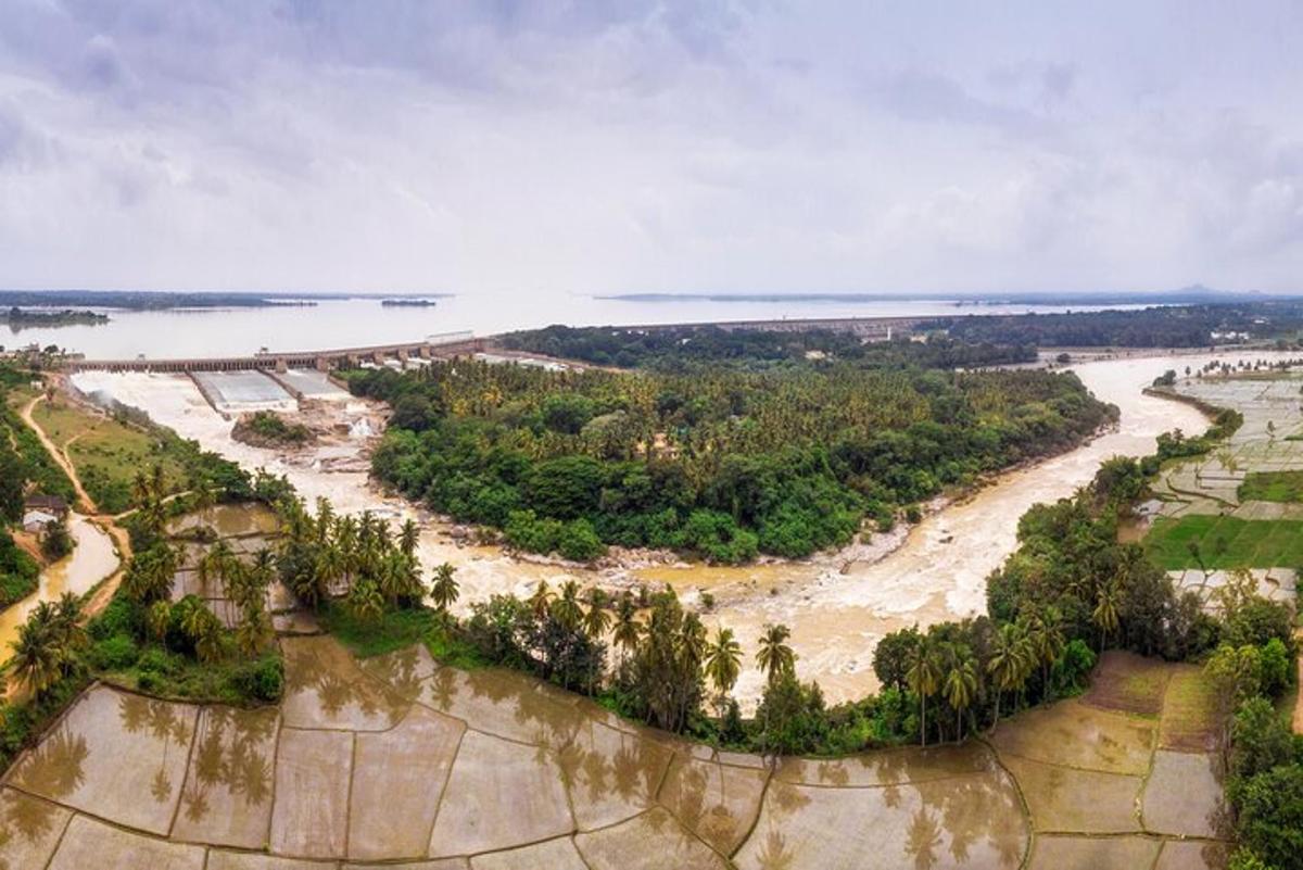 an aerial view of a river with a bridge