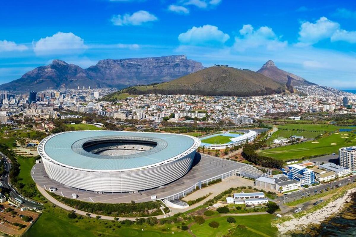 an aerial view of a soccer stadium with mountains in the background