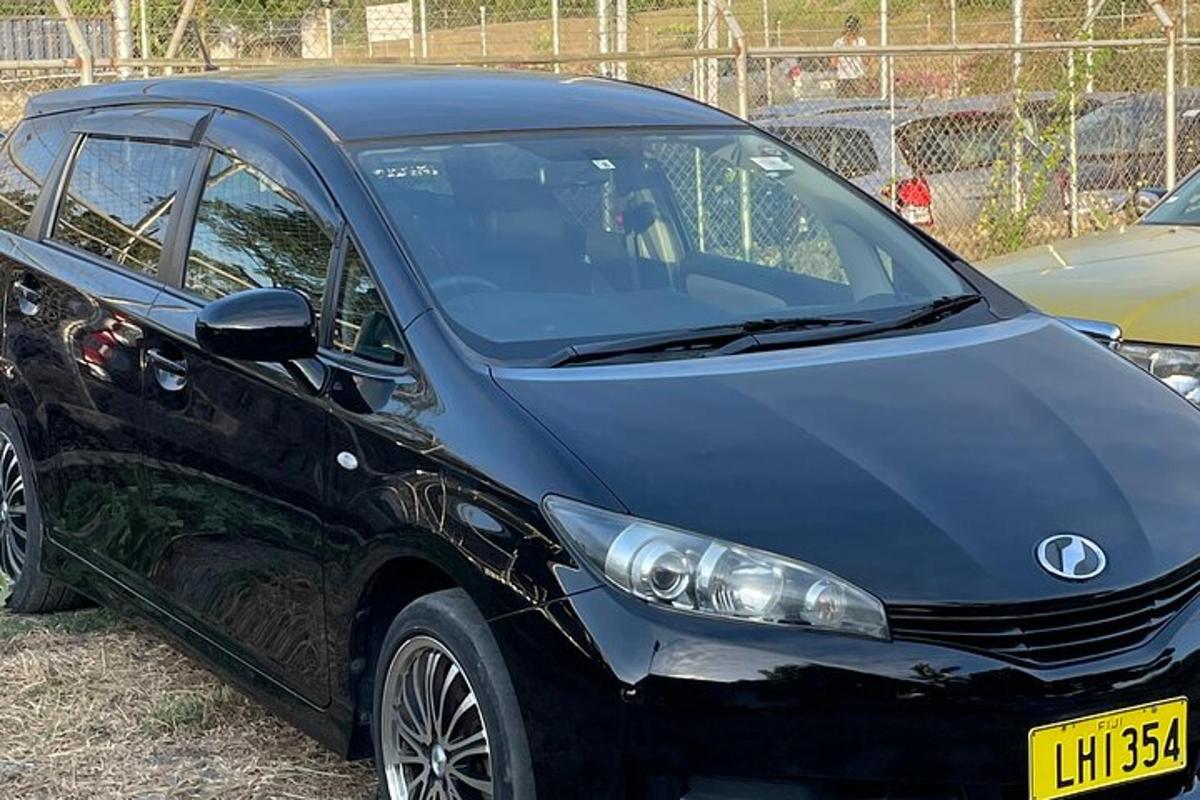 a small black car parked in a parking lot