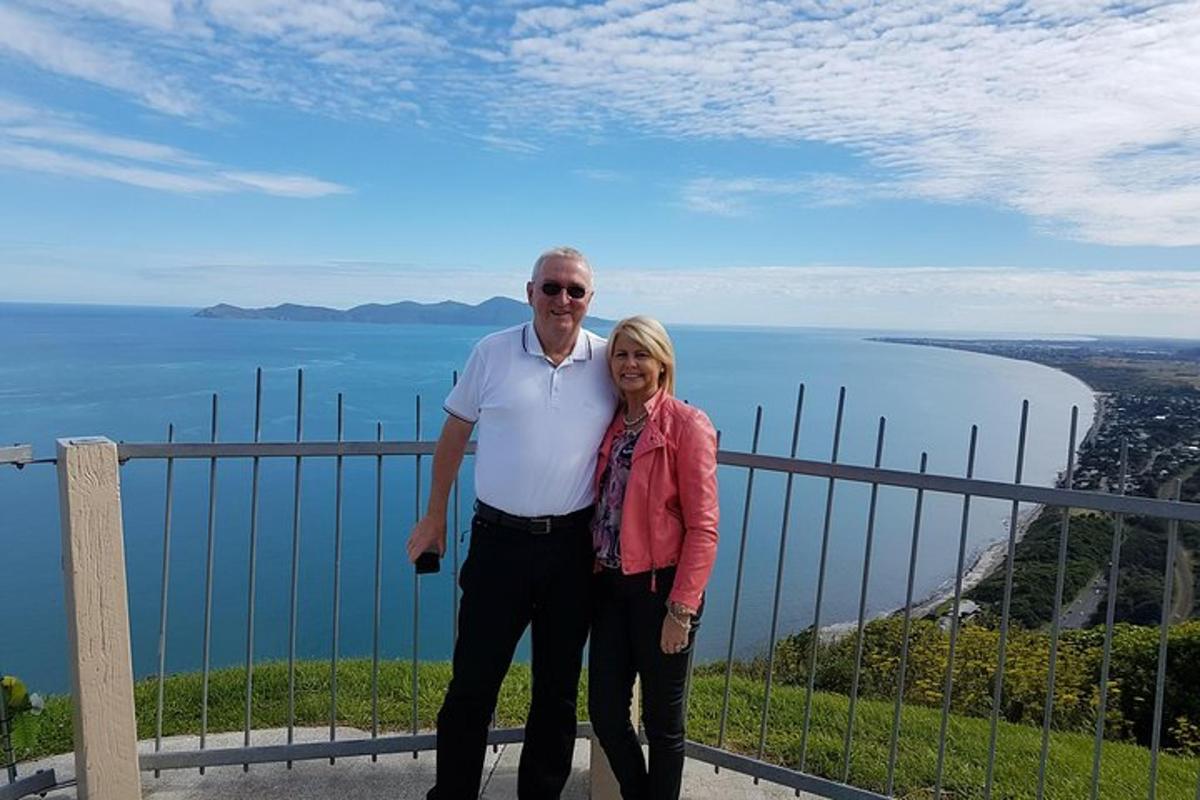 a man and a woman standing on top of a mountain