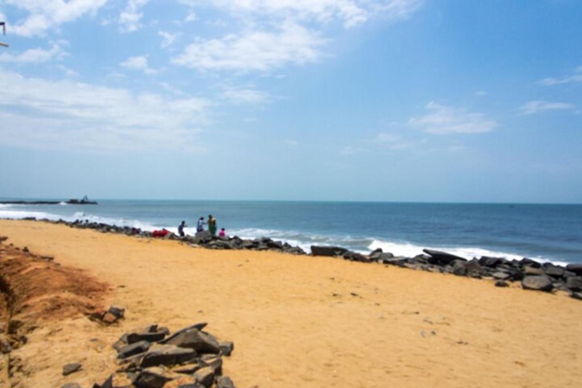 a group of people standing on a beach near the ocean