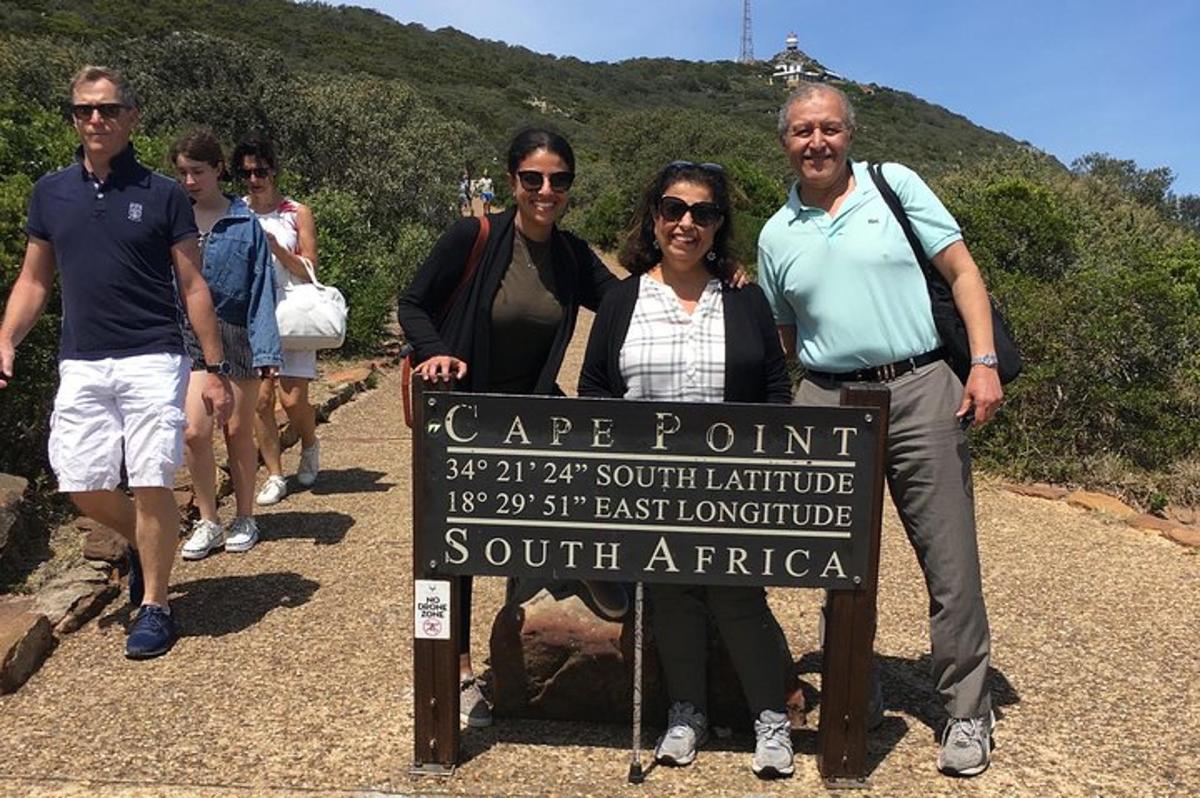 a group of people standing next to a sign