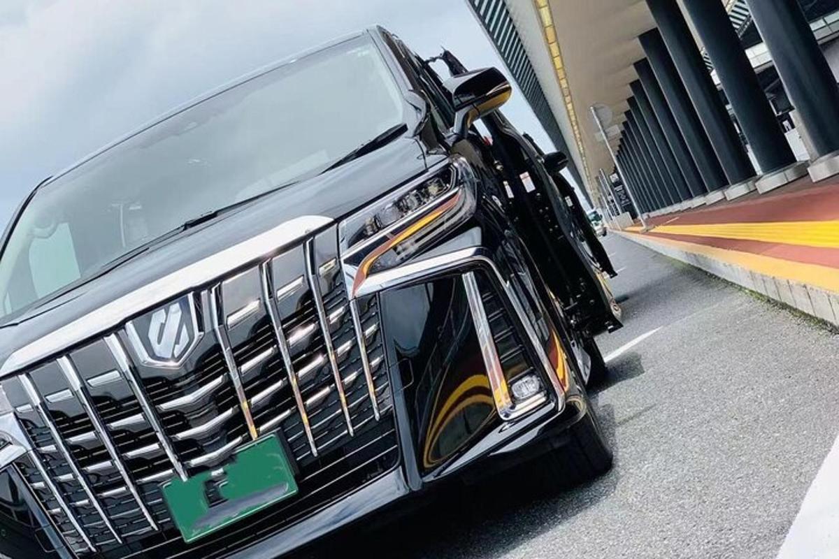 a black limousine with surfboards on the side of it