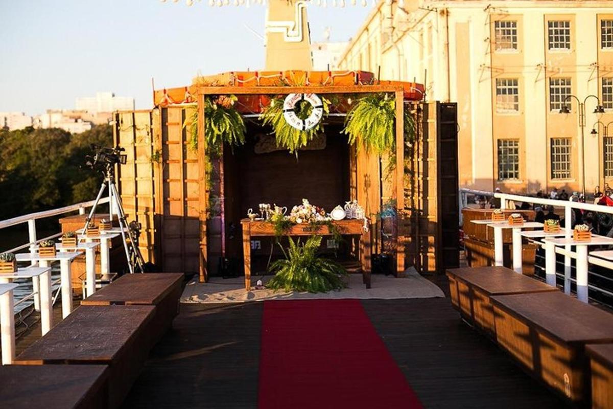 an outdoor event with a table and chairs and a stage