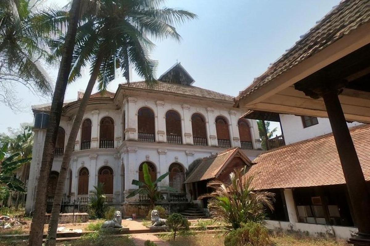 a large building with palm trees in front of it