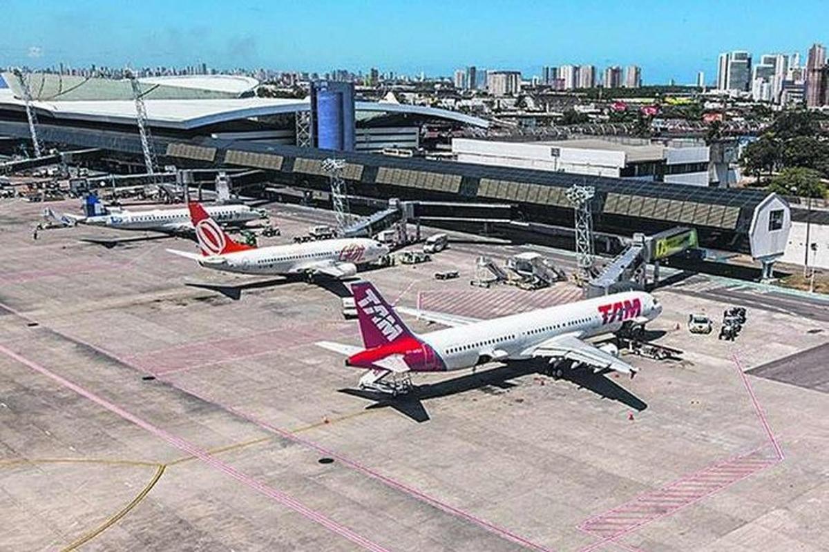 two airplanes parked on the runway at an airport