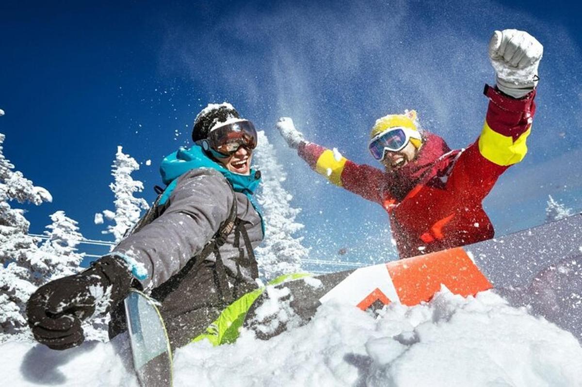 a couple of people on snowboards in the snow