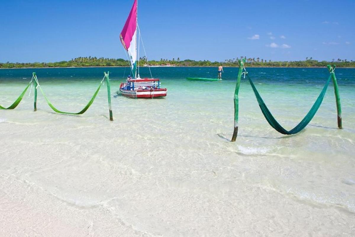 a boat sitting in the water on a beach