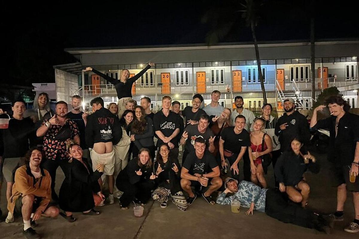 a group of people posing for a picture in front of a building