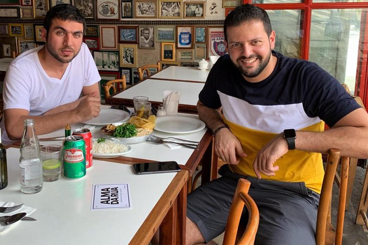 two men sitting at a table in a restaurant