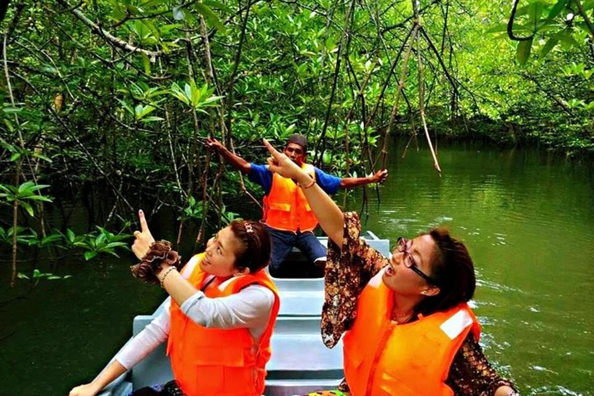 a group of people in orange vests on a boat on a river