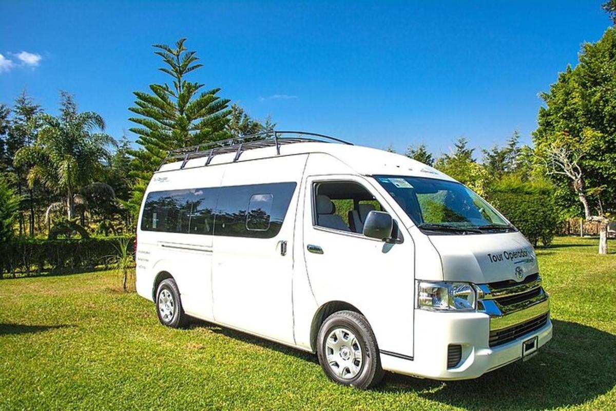 a white van parked on the grass in a field