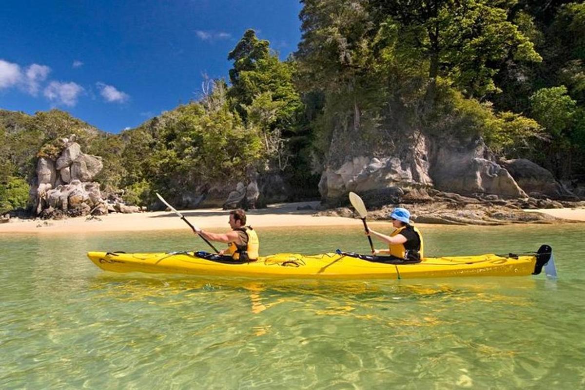 two people in a yellow kayak in the water