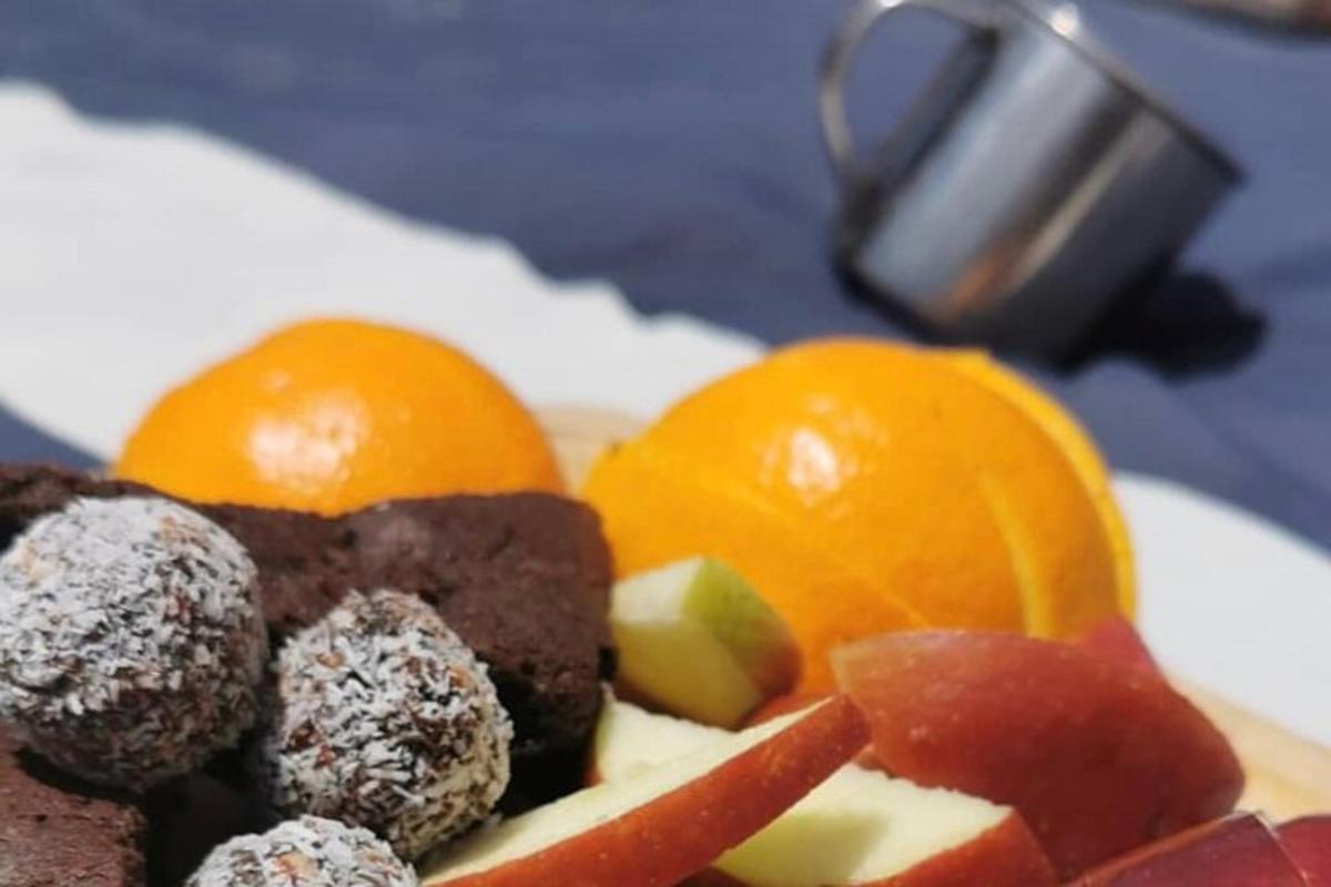 a plate of food with fruit on a table