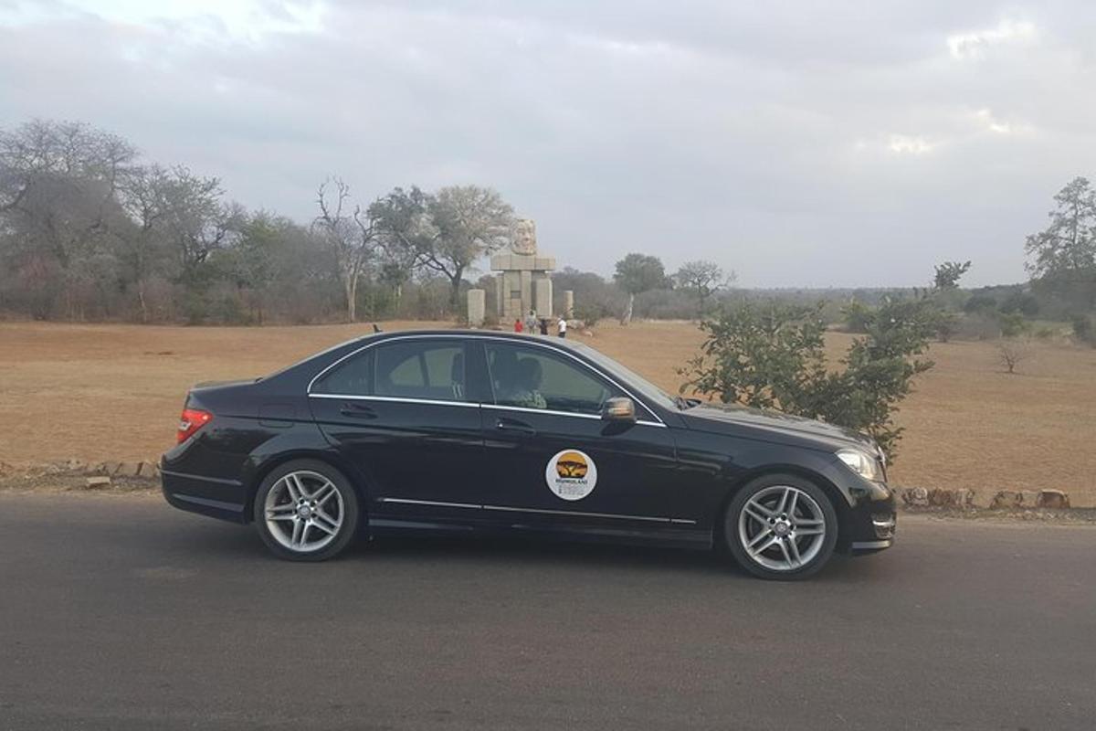 a black car parked on the side of a road